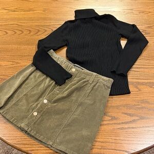 Ribbed Long Sleeve Black Turtleneck Sweater paired with Olive Corduroy Skirt